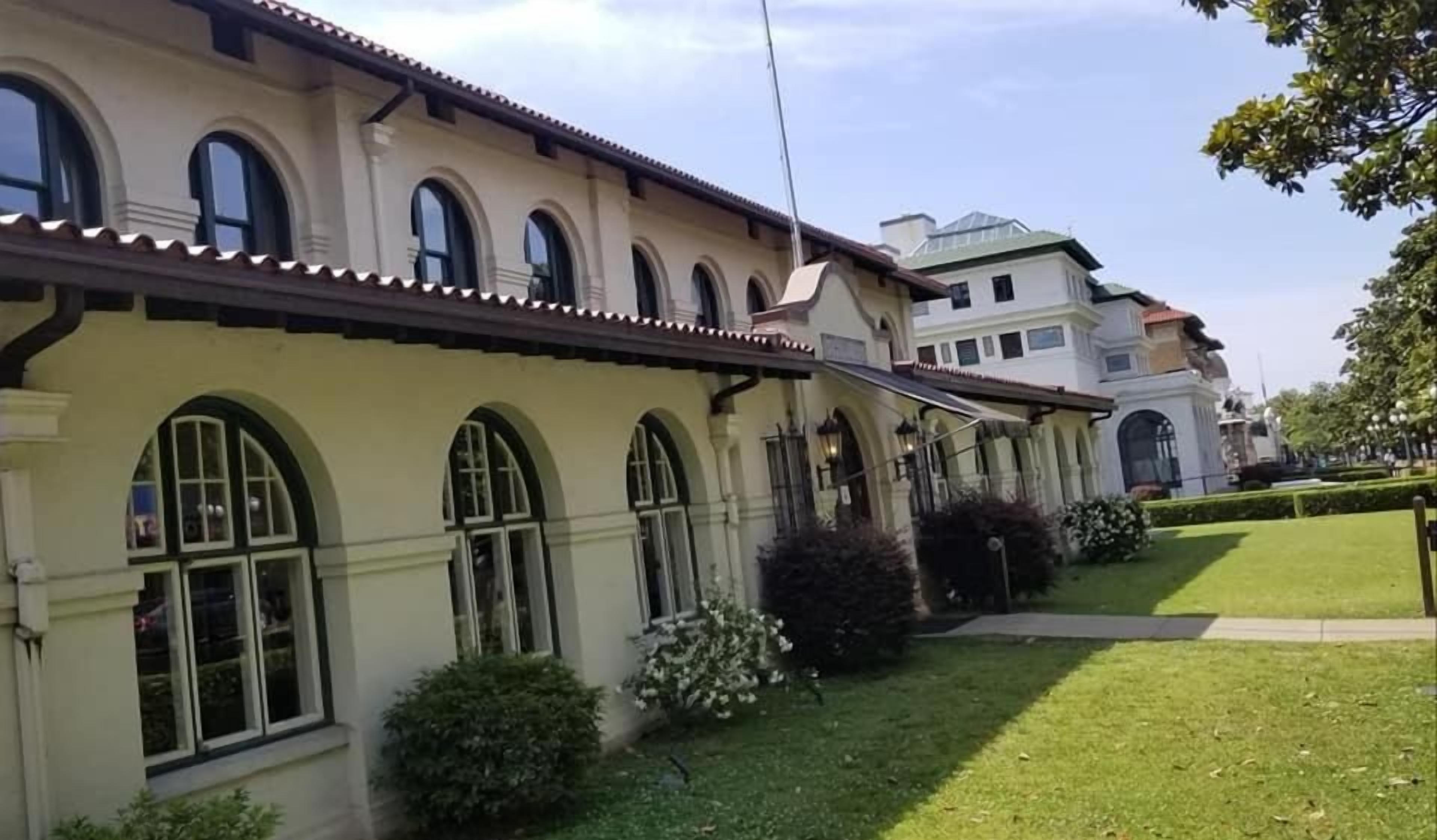 A row of buildings with arched windows and a flat roof.