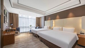A hotel room with two beds, a desk, a chair, and a view of the city through large windows. - Campanile Hotel Shenzhen Honghuashan Metro Station (Shenzhen)