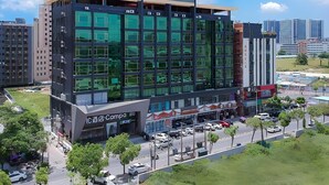 A modern hotel with a large glass facade, multiple floors, and a prominent signage. - Campanile Hotel Shenzhen Honghuashan Metro Station (Shenzhen)