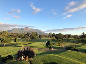 A golf course with a mountain in the background.