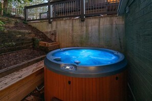 A hot tub with a control panel, surrounded by a wooden deck and a concrete wall. - Messer Manor - Downtown, Walk to Shops (Blue Ridge)