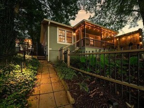 A house with a covered porch, a pathway leading to the entrance, and a fenced garden area. - Messer Manor - Downtown, Walk to Shops (Blue Ridge)