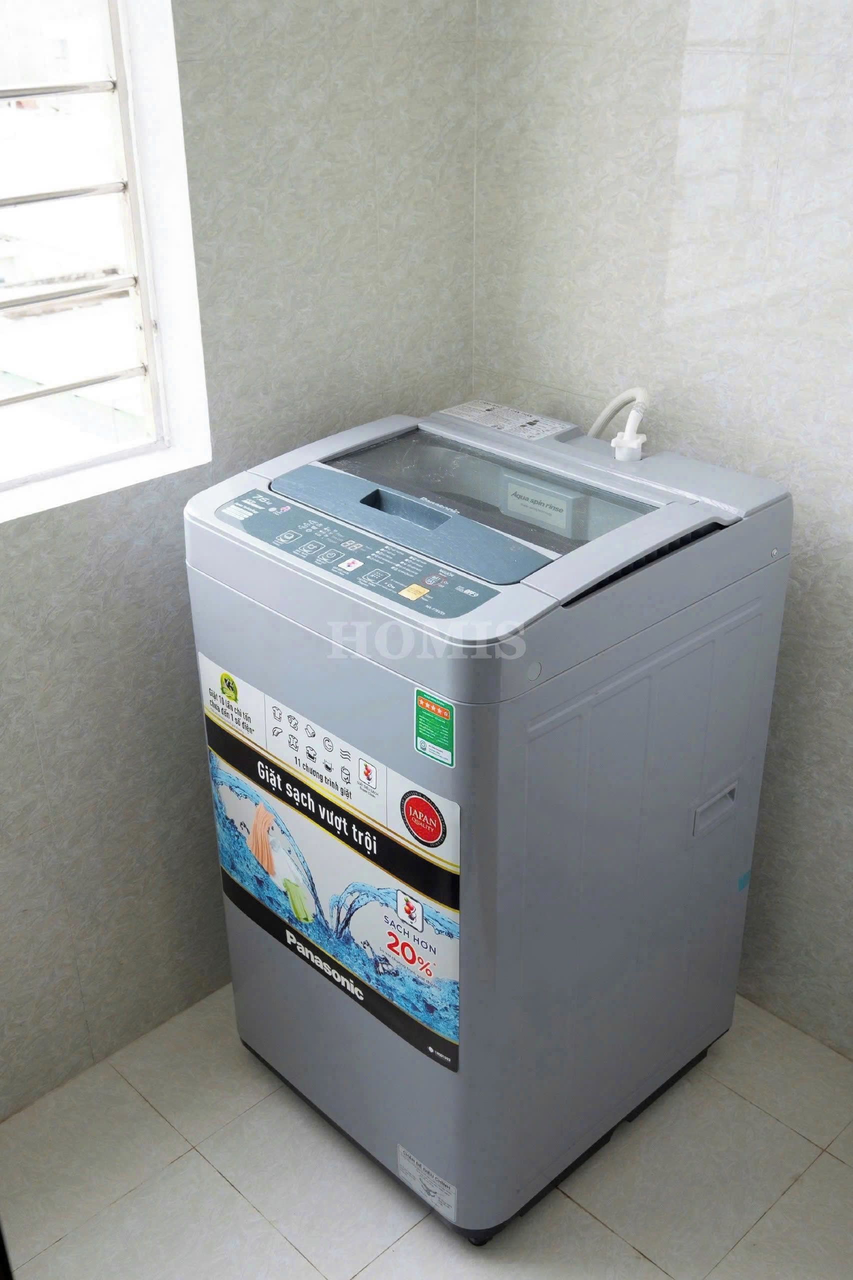 A gray water purifier with a transparent water tank, control panel, and a water inlet hose.