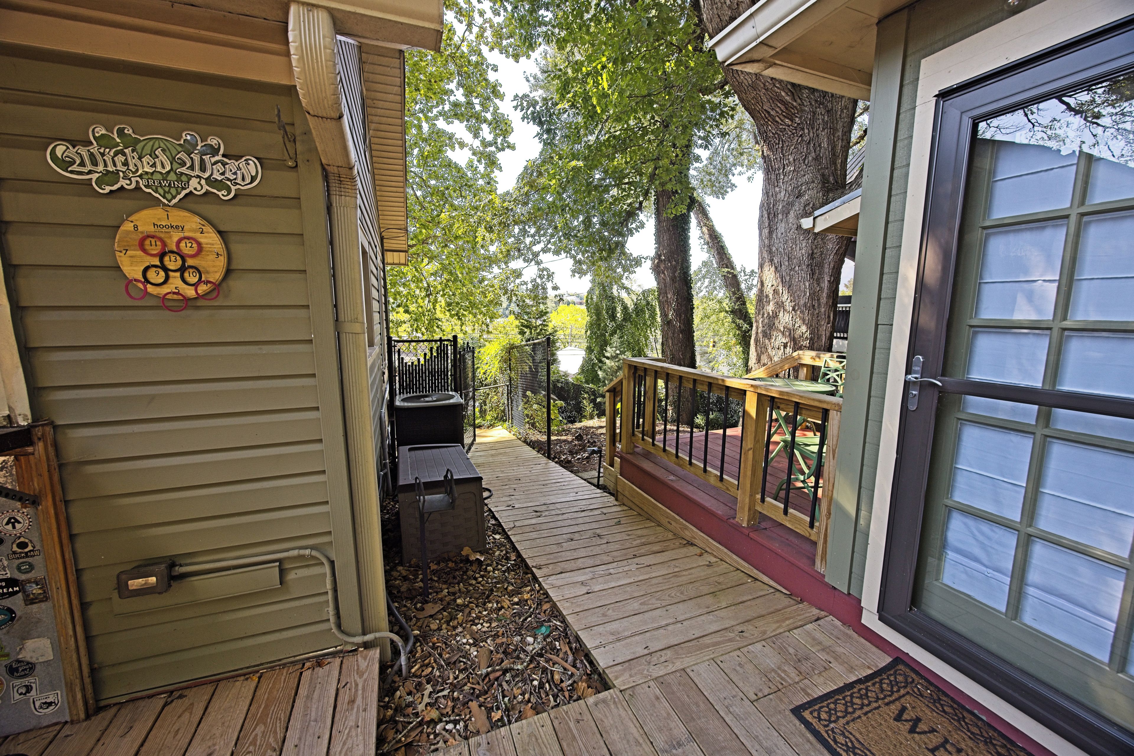 A wooden deck leading to a house with a sign reading 'Wicked Weed Brewing.'