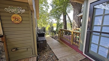 A wooden deck leading to a house with a sign reading 'Wicked Weed Brewing.'