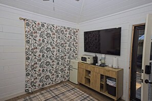 A small room with a television, a microwave, a coffee maker, and a cabinet. - Messer Loop Hideaway - Downtown, Walk to Shops (Blue Ridge)