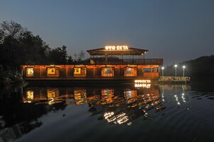 A boat with a sign reading 'OYO EKTA' on its side, floating on calm water.