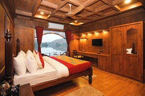 A wooden room with a bed, a desk, a television, and a wardrobe. - Ekta Houseboat Statue Of Unity Kevadia (Vadodara)