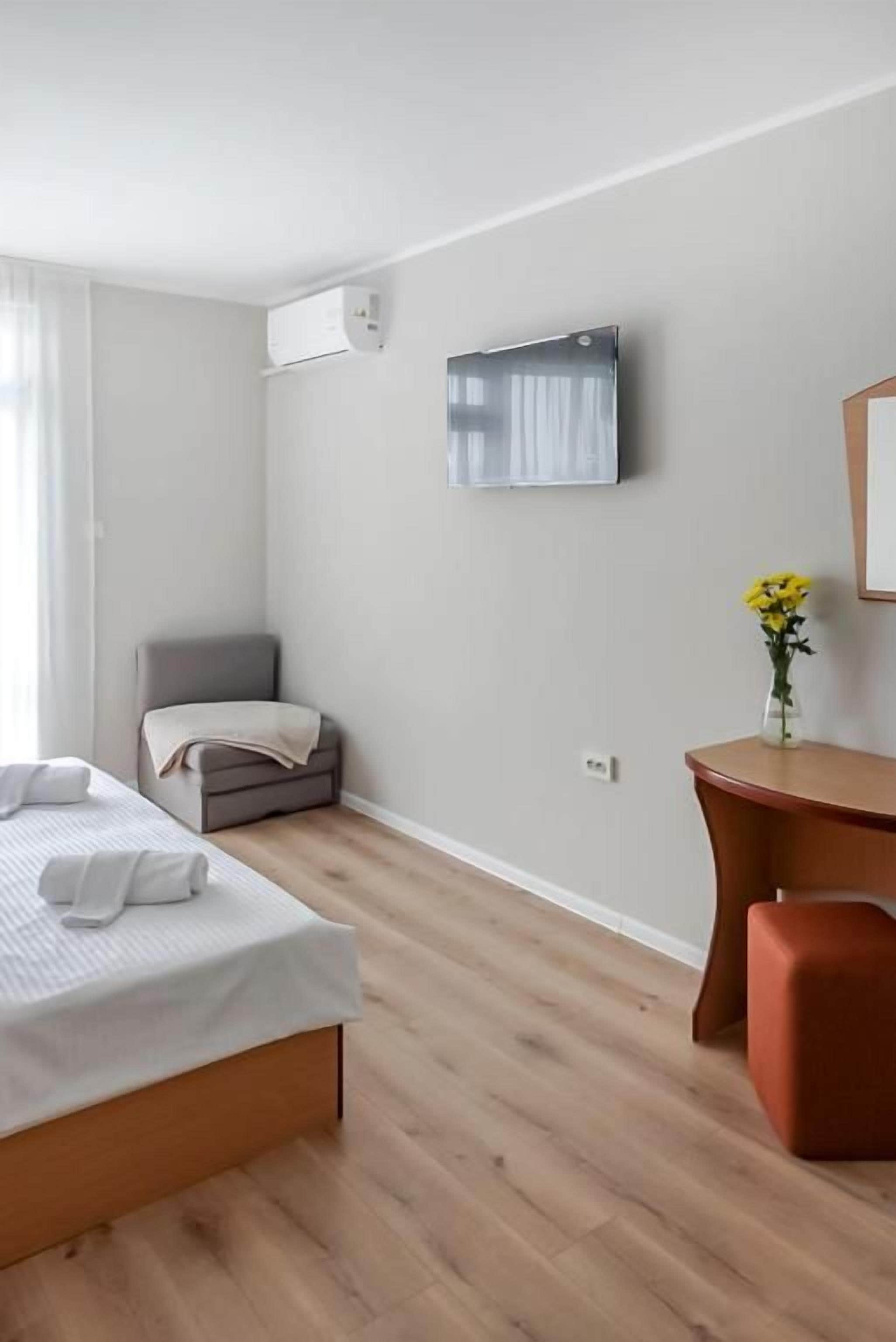 Una habitación de hotel moderna con una cama, un escritorio y una silla.
