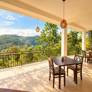 A terrace with a table and chairs, overlooking a mountainous landscape. - Claython hills ella (Ella)