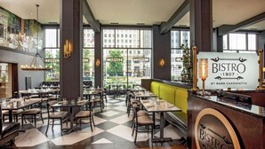 A restaurant interior with a checkered floor, wooden tables, and a bar area. - Steps From Downtown + On-Site Dining, King Bed (Youngstown)