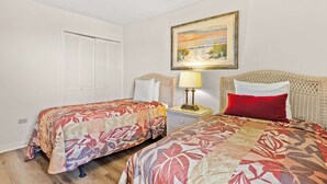 A hotel room with two beds, a nightstand, a lamp, a painting, and a closet. - 2BR Oceanfront Condo + On-site Dining, Pools & Gym (Myrtle Beach)