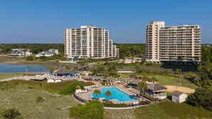 A resort with a swimming pool, multiple high-rise buildings, and a beach area. - 2BR Oceanfront Condo + On-site Dining, Pools & Gym (Myrtle Beach)