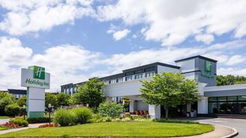 A Holiday Inn hotel with a modern design, featuring a large building with a flat roof and multiple windows.