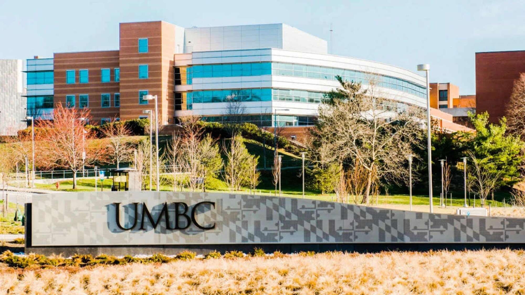 A modern building with a sign that reads 'UMBC'.