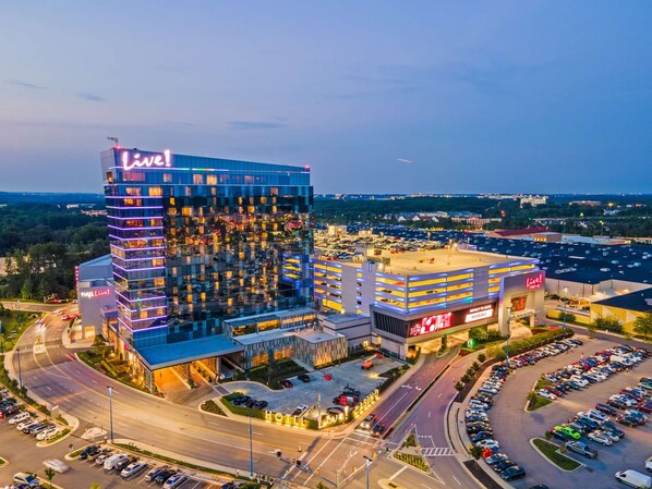 A multi-story hotel with a prominent 'Live!' sign, a parking garage, and a casino.