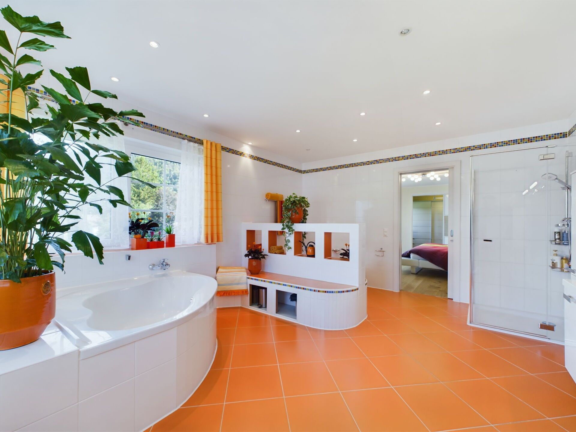 A modern bathroom with a large bathtub, a shower area, and a vanity with shelves.