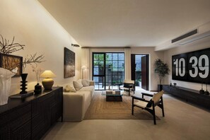 A modern living room with a sofa, coffee table, and a large window. - Daily Fortune  Tianshun River View Villa (Chongqing)