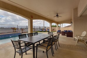 An outdoor patio with a pool, dining table, and lounge chairs. - Mtn Views, Hot Tub! Extended Lake Havasu Escape (Lake Havasu City)