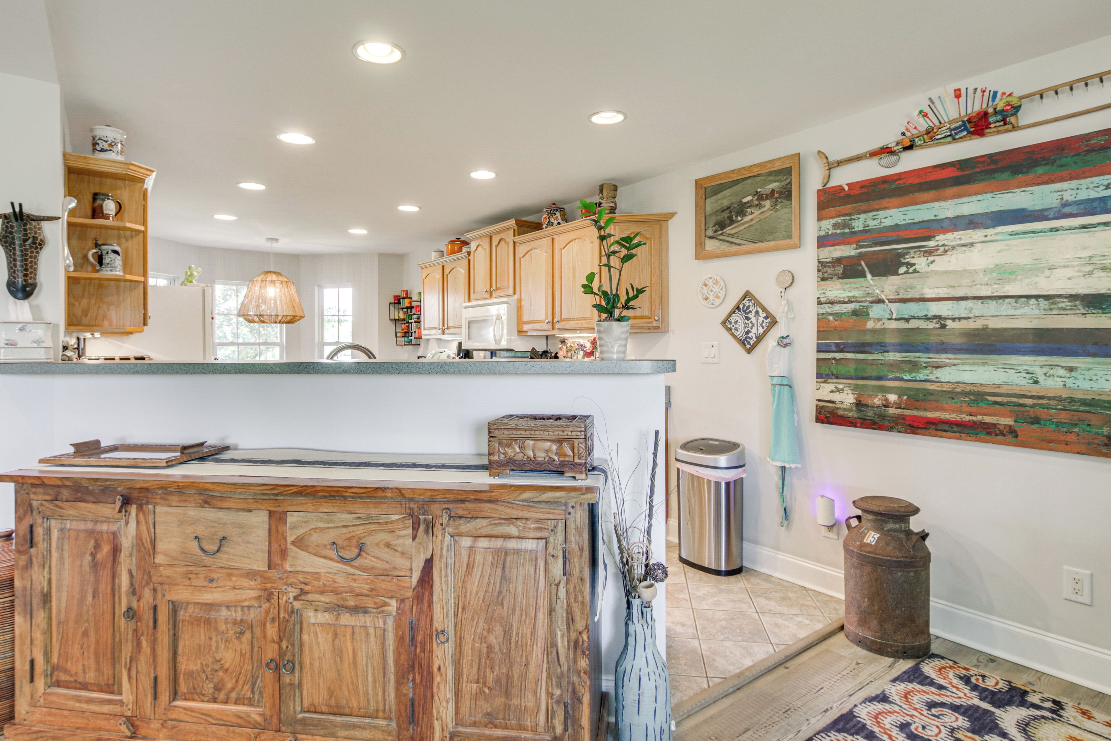 A kitchen with wooden cabinets, a central island, and a rustic decor theme.