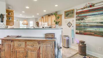 A kitchen with wooden cabinets, a central island, and a rustic decor theme.