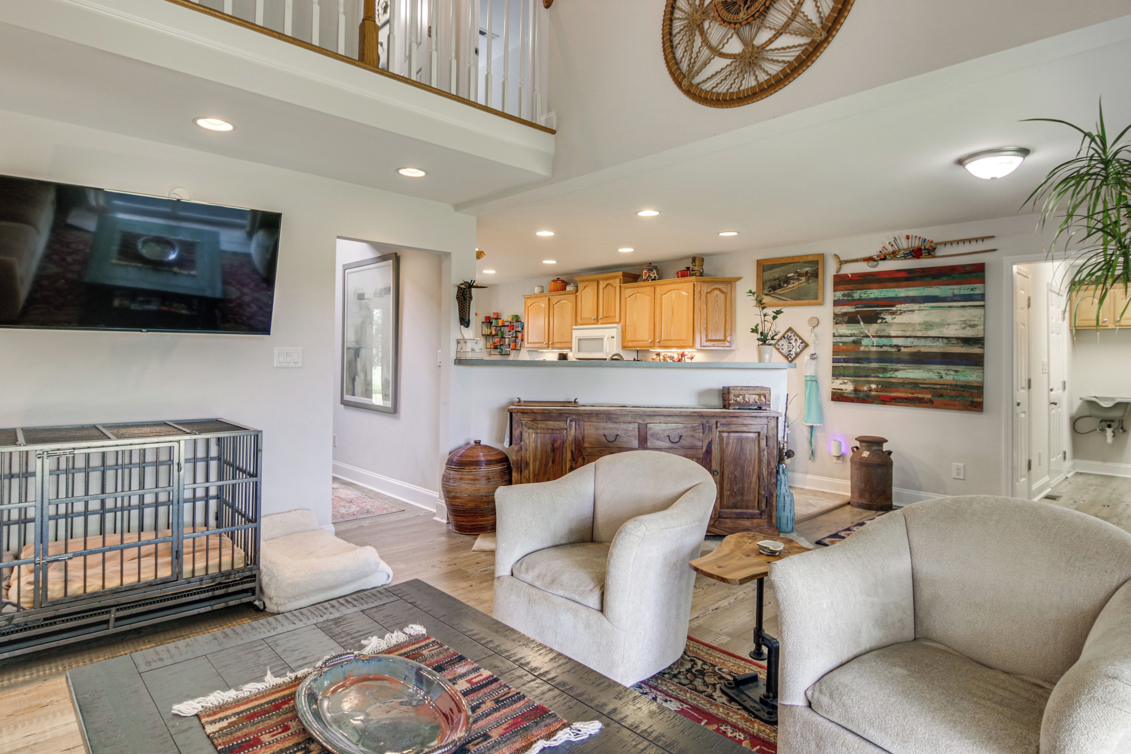 A spacious living room with a large television, a sofa, and a coffee table.