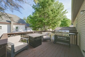 A deck with outdoor furniture, a grill, and a large tree. - Walk to Lake & Downtown! 6 Mi to Boyne Mtn (Boyne City)