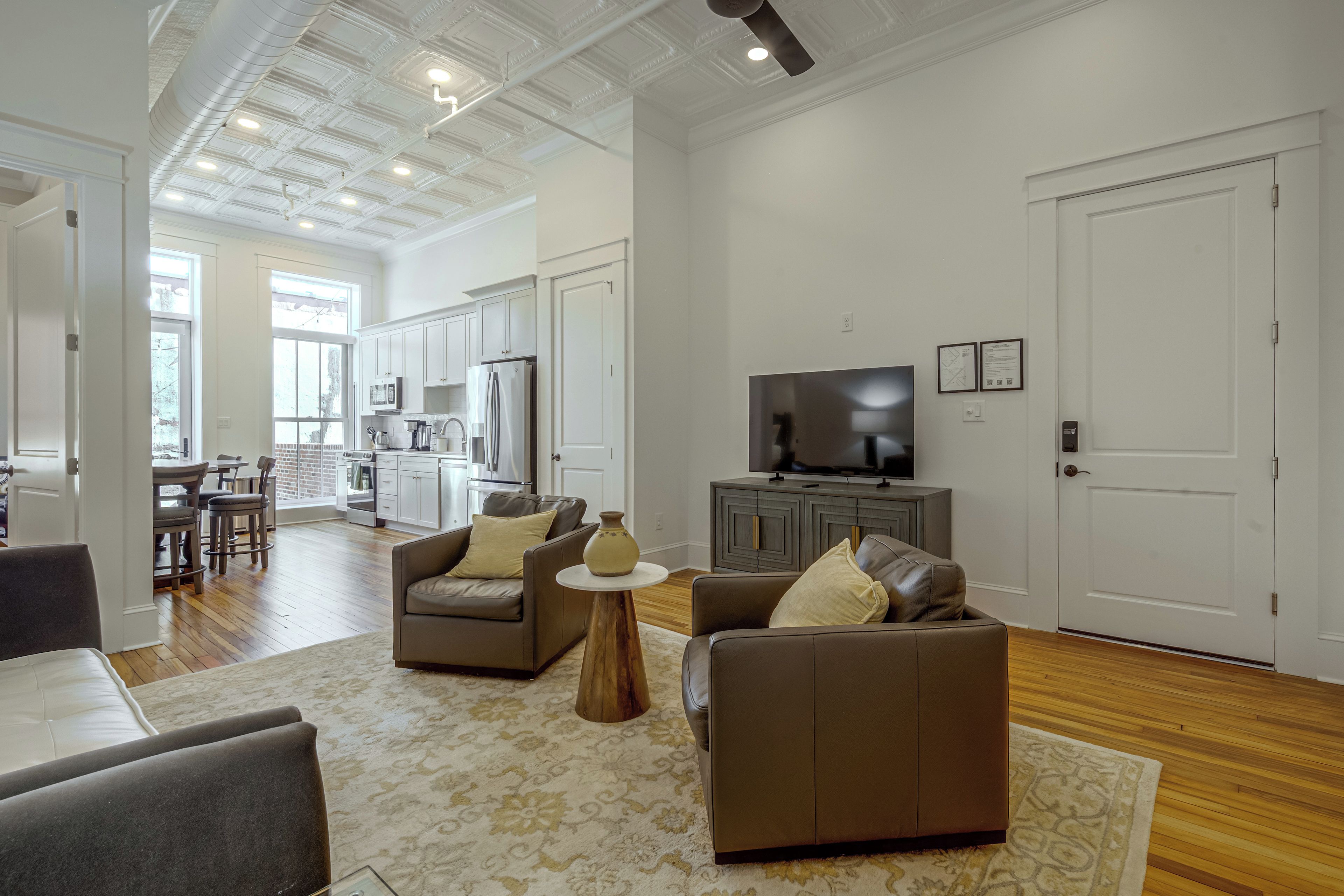 A modern living room with a sofa, a coffee table, and a television.