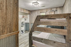 A bunk bed with a wooden frame, a white ceiling with a light fixture, and a white wardrobe with hanging clothes. - 115-acre Retreat w/ Private Lake in Maysville (Maysville)