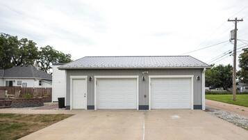 A two-car garage with a metal roof and white garage doors.
