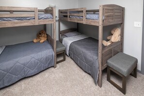A bunk bed room with a dog and a stuffed rabbit toy.