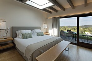 A bedroom with a large bed, bedside lamps, a bench, and a balcony with a view. - Mas De Torrent (Torrent)