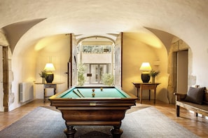 A pool table in a room with arched ceilings and two lamps on side tables. - Mas De Torrent (Torrent)