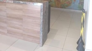 A reception area with a marble counter and a large mural depicting various animals and people. - Hotel Grande Rio (Petrolina)
