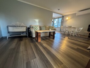 A living room with a sofa, a coffee table, and a dining area with chairs. - Entire villa in Metford, 
A relaxing, homey stay — ideal for short breaks (Metford)