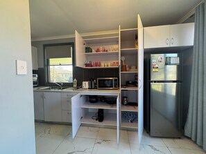 A kitchen with a built-in microwave, a refrigerator, and a window. - Entire villa in Metford, 
A relaxing, homey stay — ideal for short breaks (Metford)