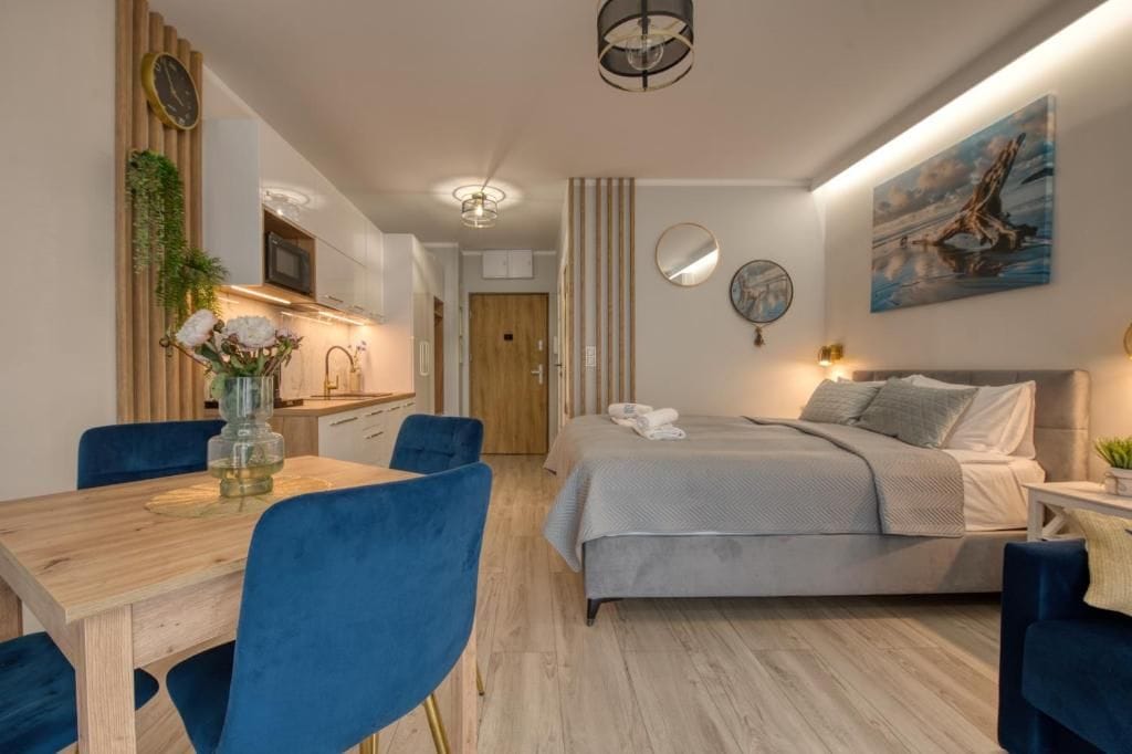 A modern bedroom with a bed, bedside table, and a painting on the wall.