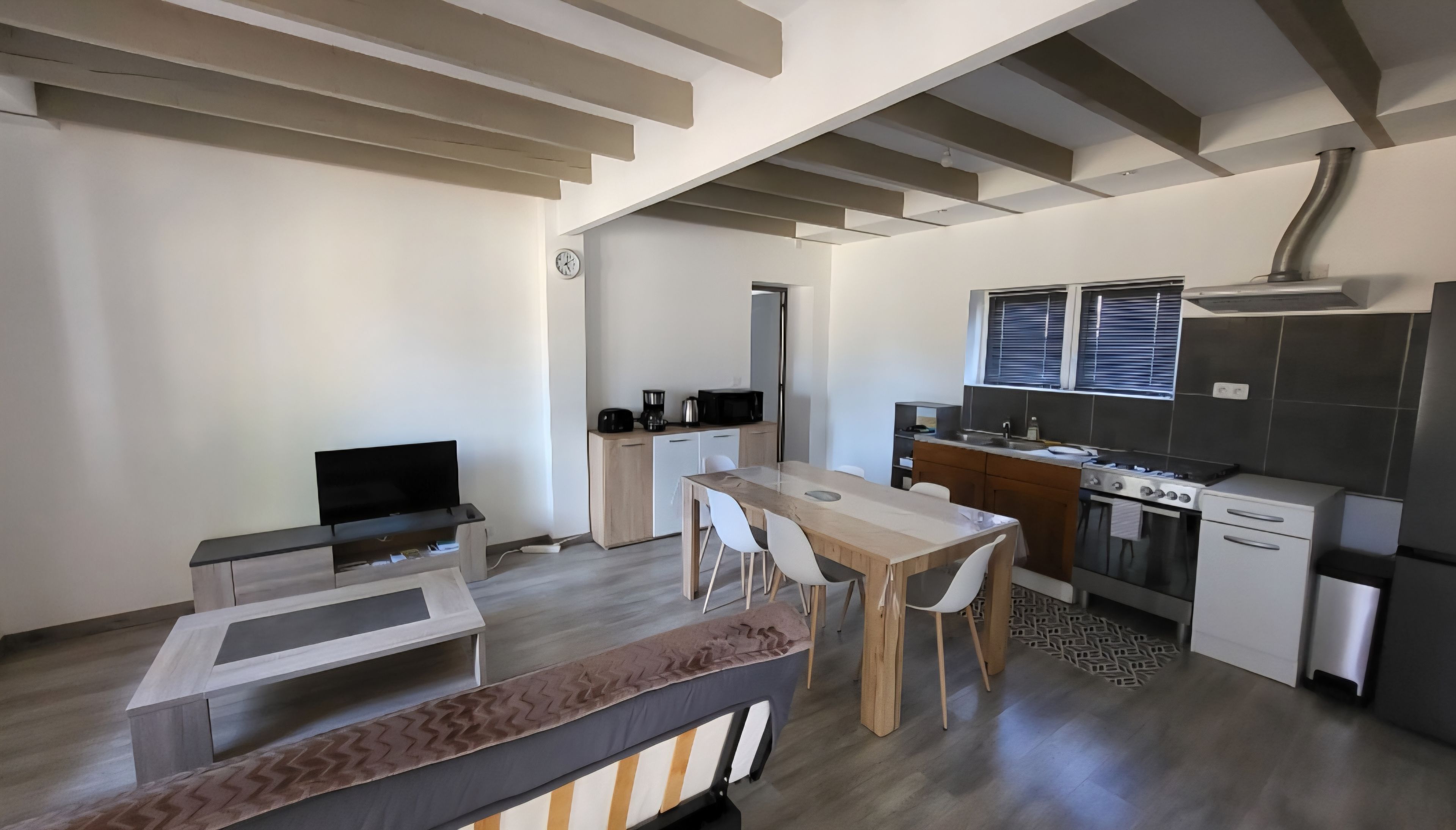 A modern kitchen with a microwave, stove, and sink.