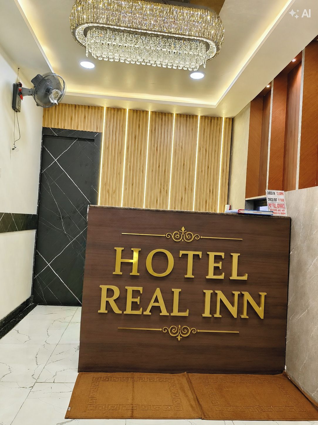 A hotel reception desk with a sign that reads 'HOTEL REAL INN'.