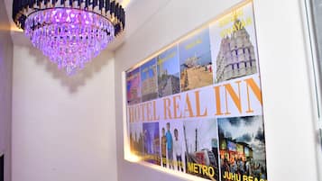 Una pared con una araña y un cartel de un hotel llamado HOTEL REAL INN.
