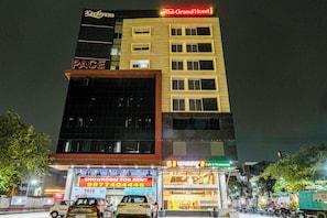 A multi-story building with signage for 'The Grand Hotel' and 'PACE' at the ground level.