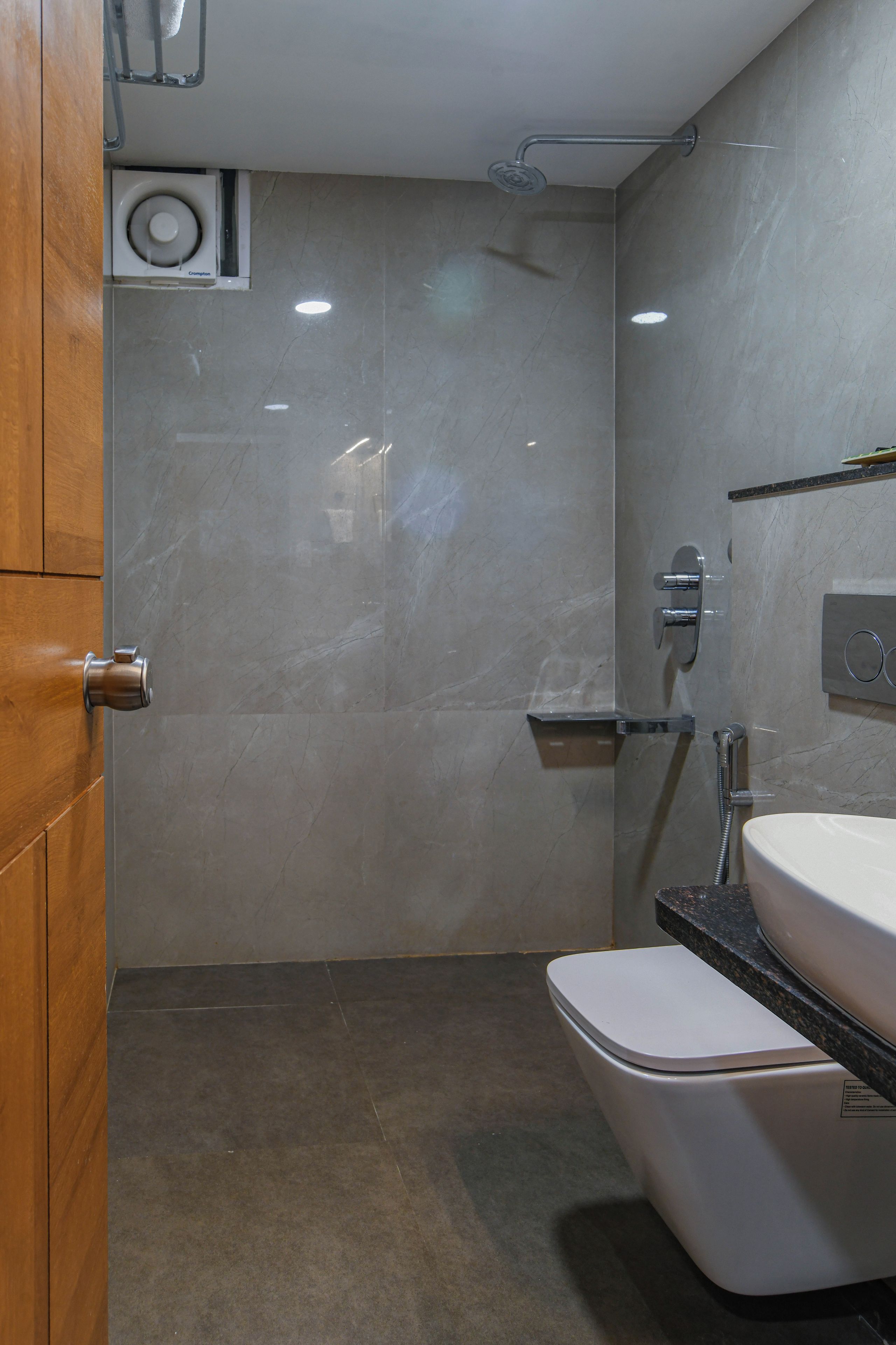 A bathroom with a toilet, sink, and shower.