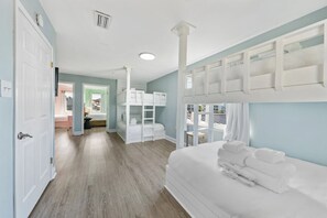A hotel room with bunk beds, a walk-in closet, and a view of the city. - Boat-Friendly Waterfront Luxury Home in Gulf Shores | Sleeps 19 (Gulf Shores)