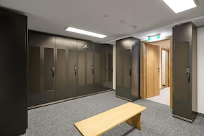 A hallway with lockers, a bench, and a door leading to another room. - Modern Suite With Garden or Loggia (Gaschurn)