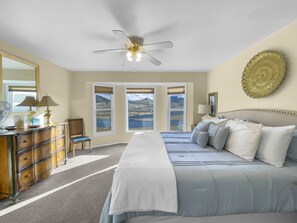 A bedroom with a bed, dresser, chair, and a ceiling fan. - Forever Family Farm 3 Bedroom Home (Montrose)