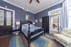 A bedroom with a bed, bedside tables, a chair, and a door. - The Veranda - Sunrise. Sunset. Romance. Historic Pensacola (Pensacola)