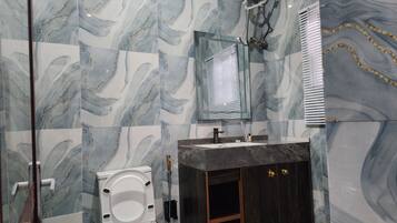 A bathroom with a toilet, sink, and mirror.