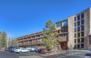 A multi-story hotel with a stone facade and multiple balconies. - Texas Colorado Two Step | AC, Pool, Hot Tub, Golf & Ski (Durango)