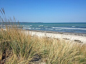 A beach with sand and grass in the foreground, and the ocean in the background. - Only about 750 meters from the beach, fireplace, Wi-Fi, washing machine, dryer, sleeps up to 4 people (Breege)