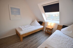 A small, single-bed room with a sloped ceiling and a window. - Only about 750 meters from the beach, fireplace, Wi-Fi, washing machine, dryer, sleeps up to 4 people (Breege)